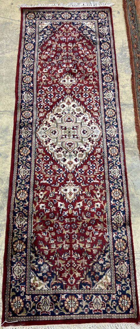 A Caucasian blue ground rug, 128 x 89cm, a Persian style red ground mat and a gold ground rug